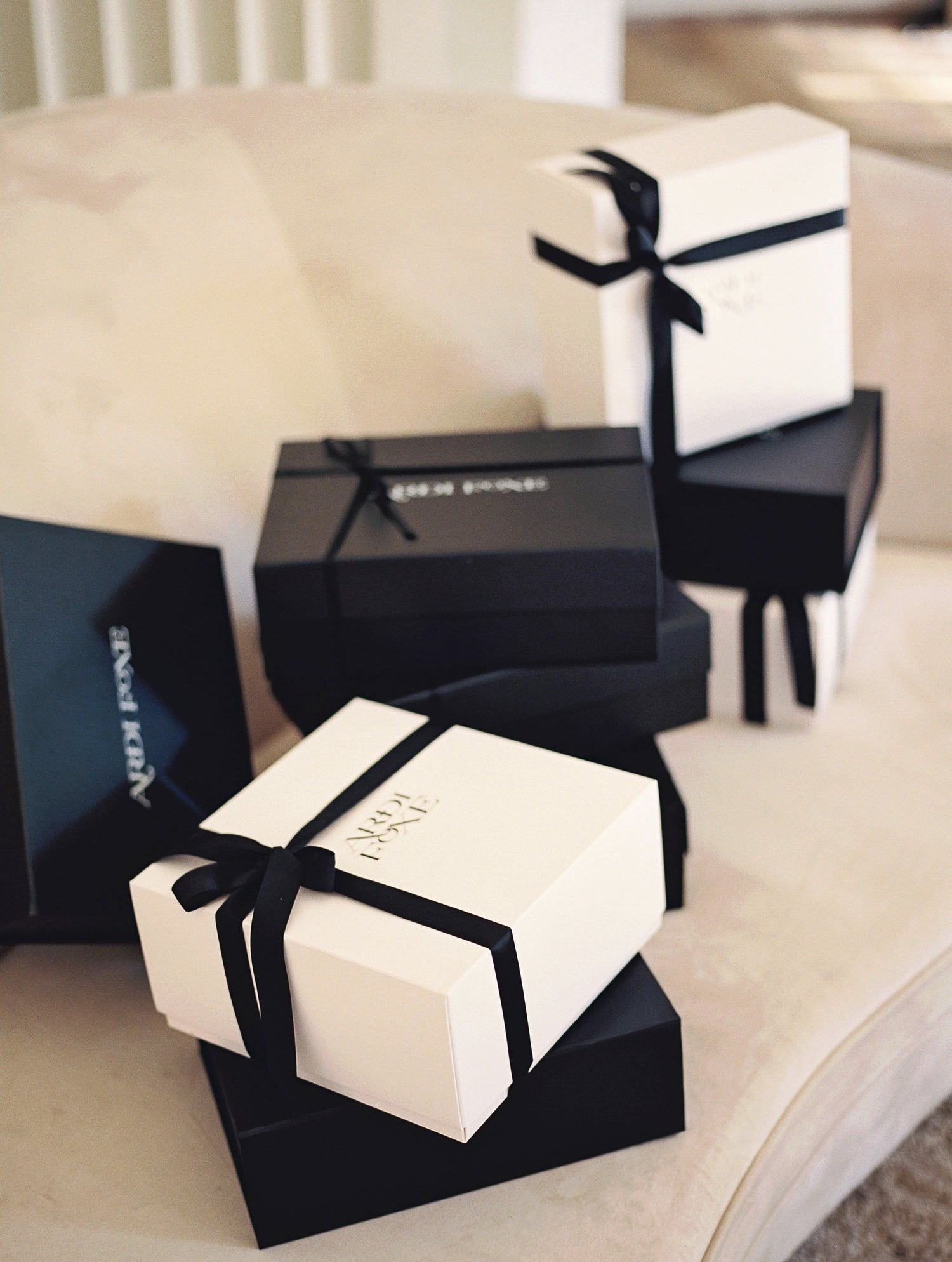 ardi foxe black and white gift boxes on sofa