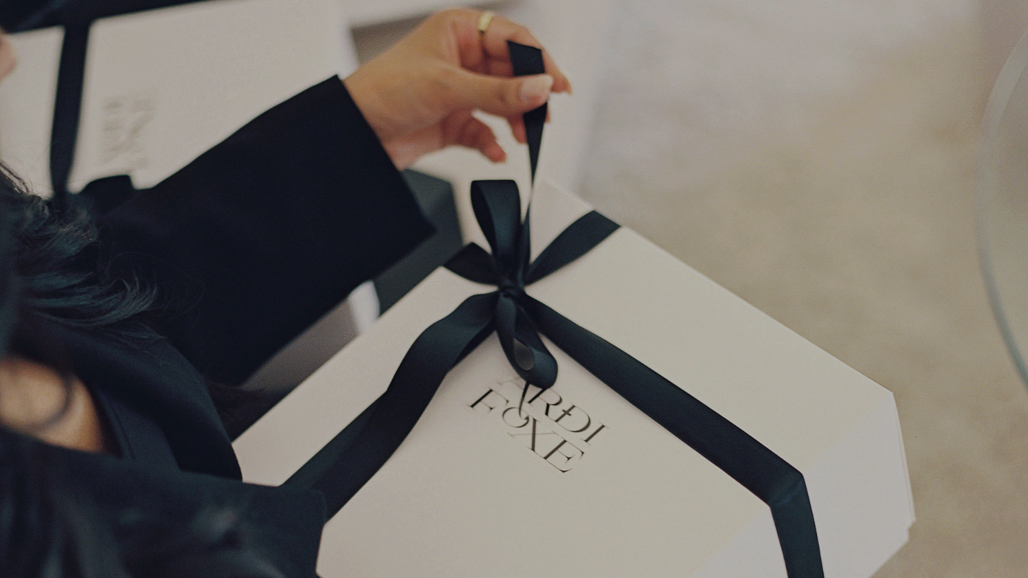 ardi foxe unwrapping white box banner